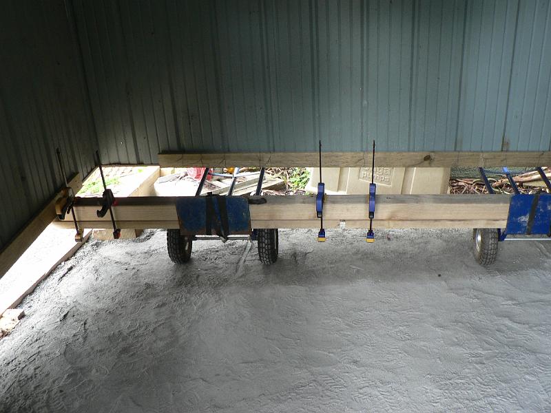 P1010082.JPG - This is where the fun starts. The shed is in the way of the tank. How do 2 people move a heavy large wobbly steel shed 3m to one side, without dismantling it? With a shed trailer of course. A what?Parts list: 2 sack trucks, 6 large clamps, 3m post and 2x1.8m posts for bearer. 4x2.5m planks for strengthening the sides of the shed. Clamp and wire together. Don't shake the shed too much....Add 2 guys at the other end to lift and pull...
