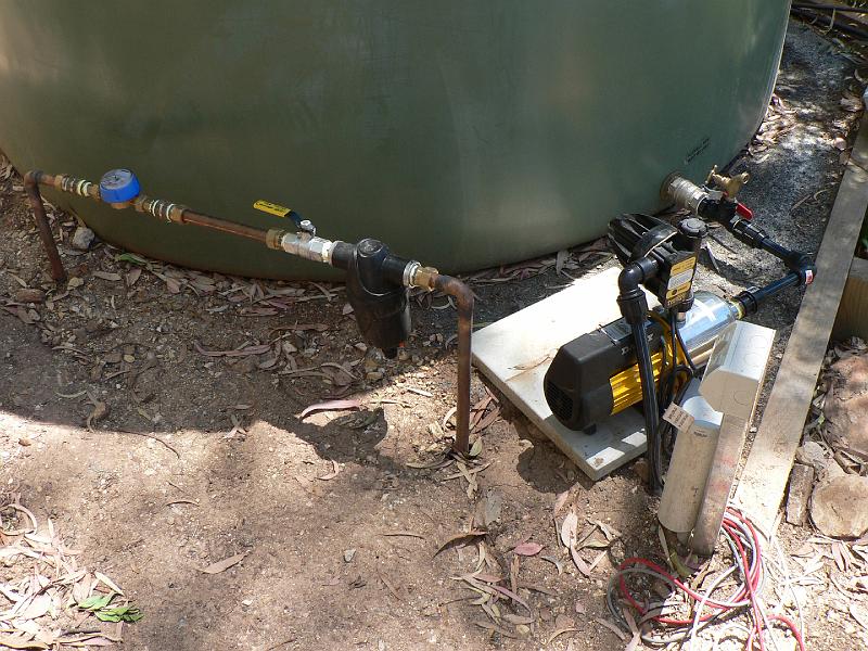 P1010141.JPG - Constant pressure pump, 20um sediment filter, and water meter. Data cable for water meter and TBD. There's a mechanism at the house to switch over to mains water if the rainwater runs out. Rainwater is plumbed to everything in the house except for cold water to showers/baths, and toilets.
